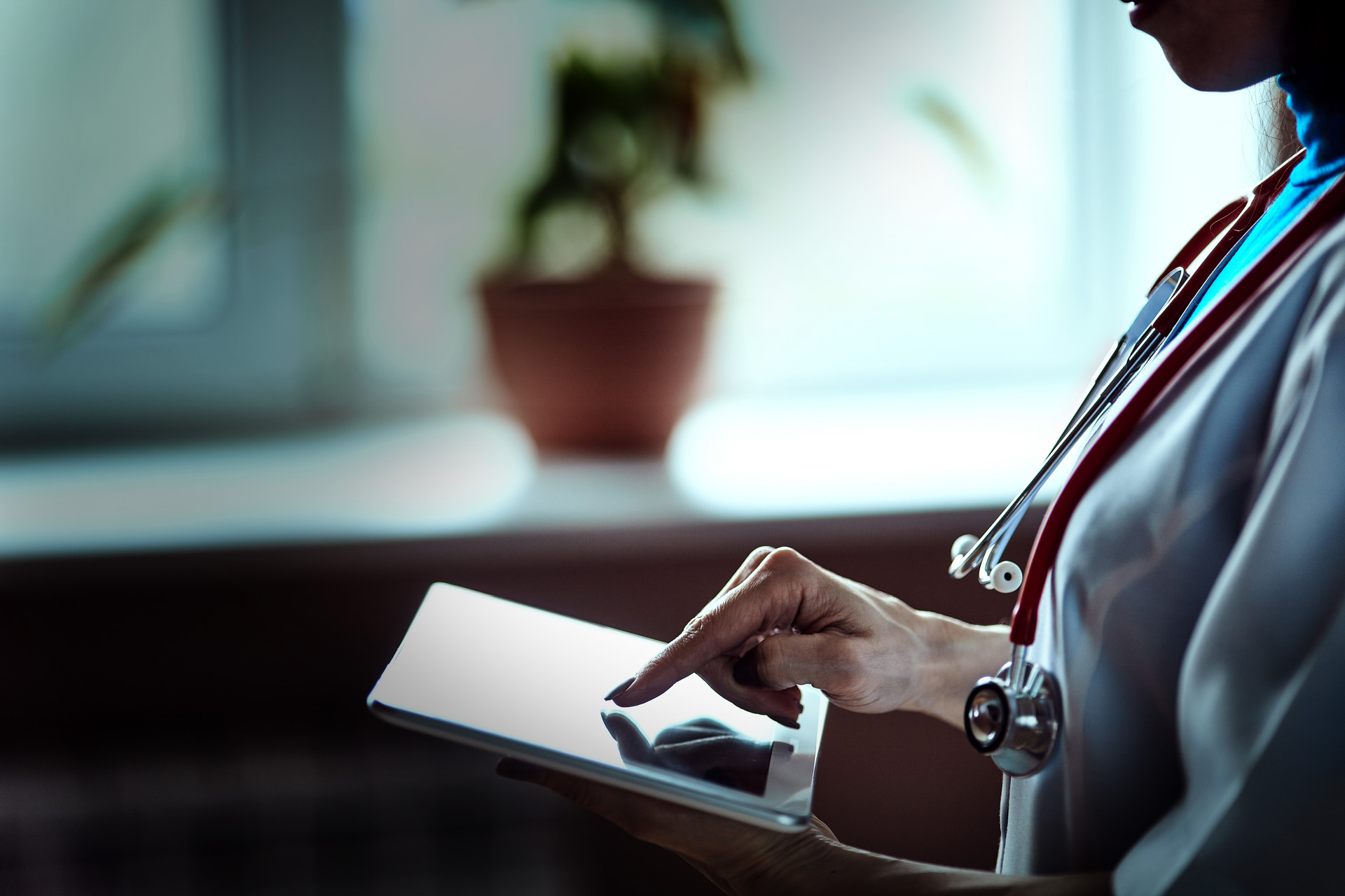 Doctor working on a digital tablet with copy space