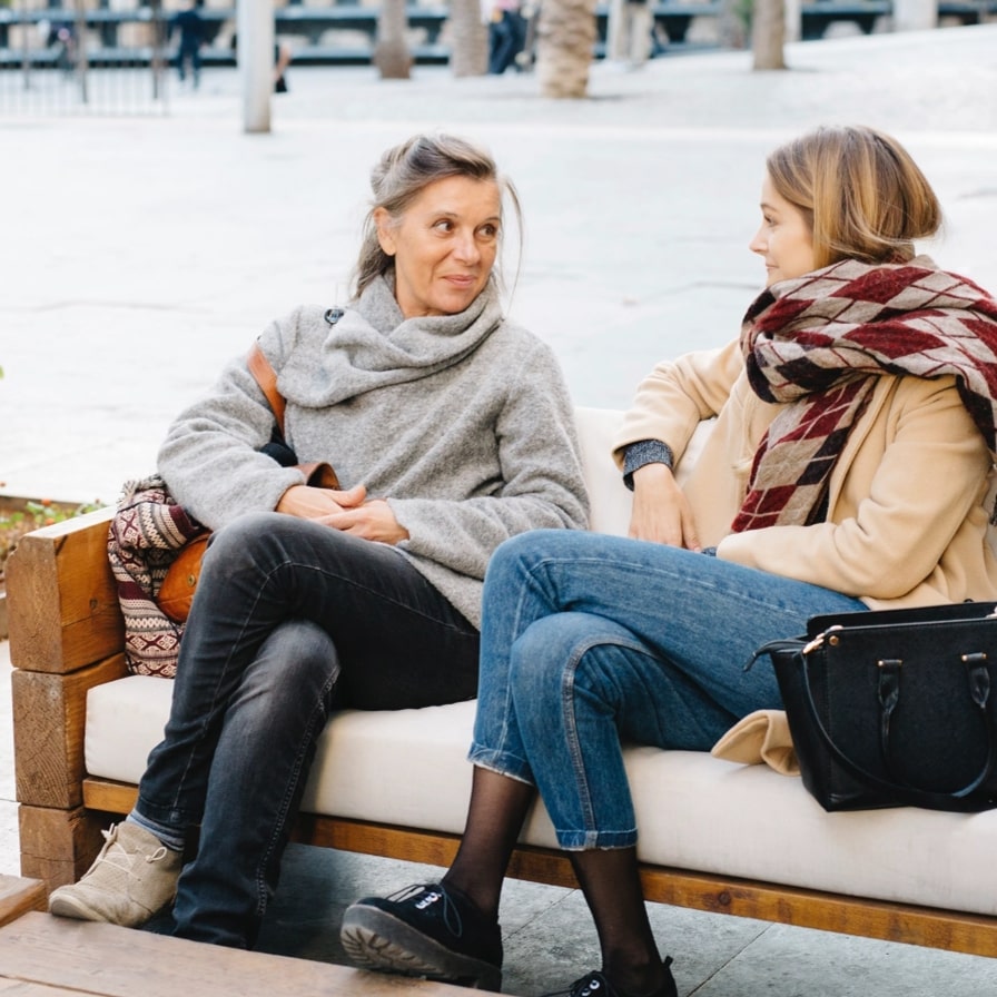 two women sitting in park